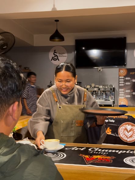 Student presenting latte art at Caffinity Balaju campus